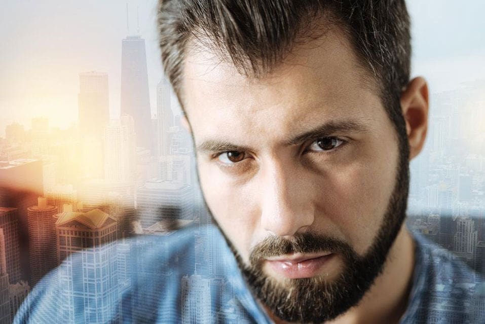 guy staring with city in background