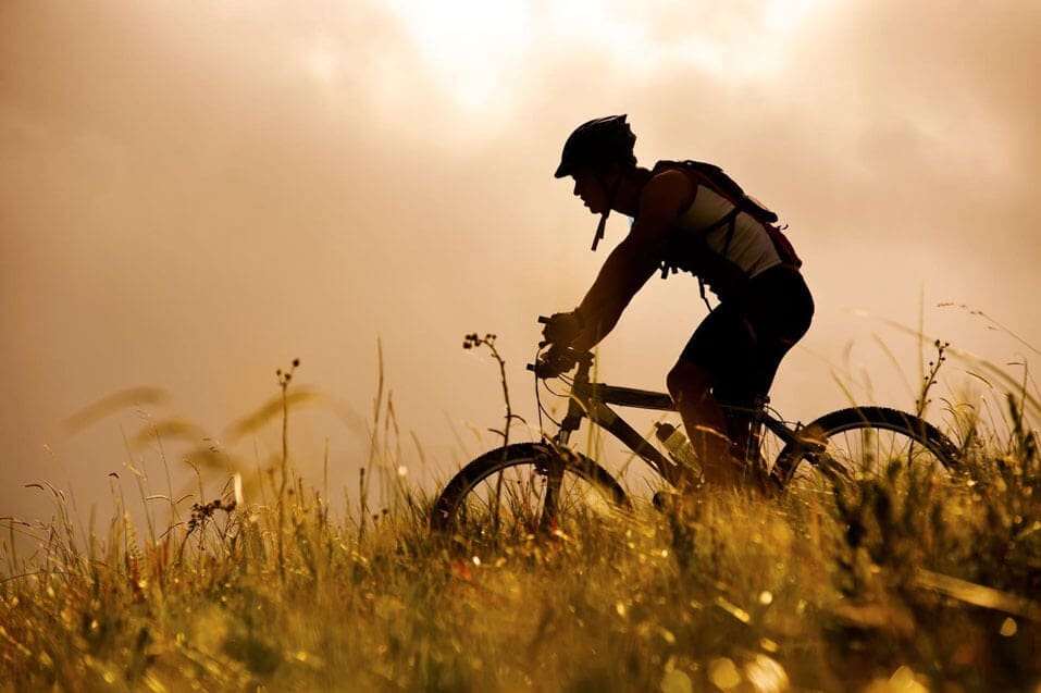 A shot taken of a man riding his bike in the evening