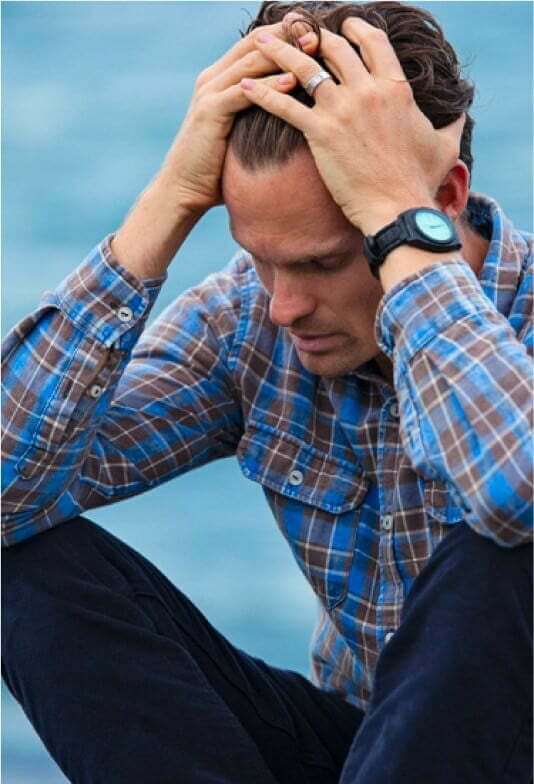 Man holding his head struggles through alcohol detox on his road to recovery at Prosperity Haven