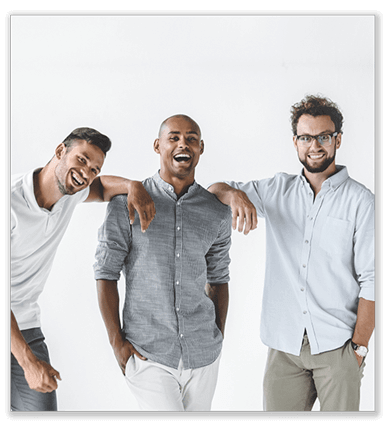 Three young guys are laughing and smiling toward the camera.