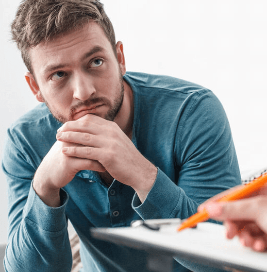 Man in blue shirt looking at paperwork
