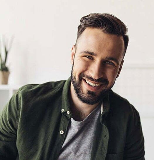 Man Smiling with a green jacket