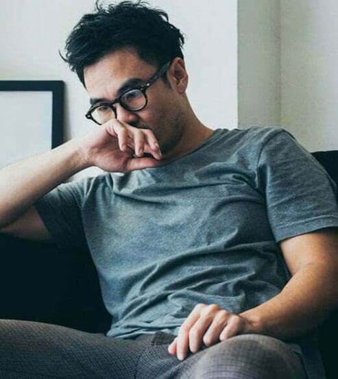 Man in a blue shirt and black glasses