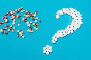 A question mark made of pills.
