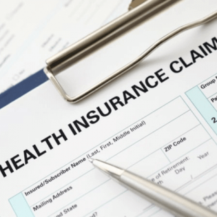 A health insurance claim form with a pen on top at an addiction recovery center.